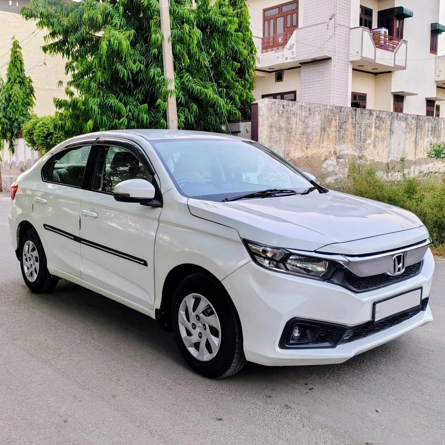 Clean sedan operating as an Amritsar taxi service near heritage city landmarks.